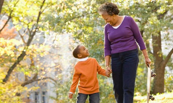 An older woman and child walking hand in hand