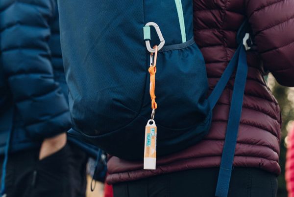 Rucksack on woman's back with lip balm on toggle