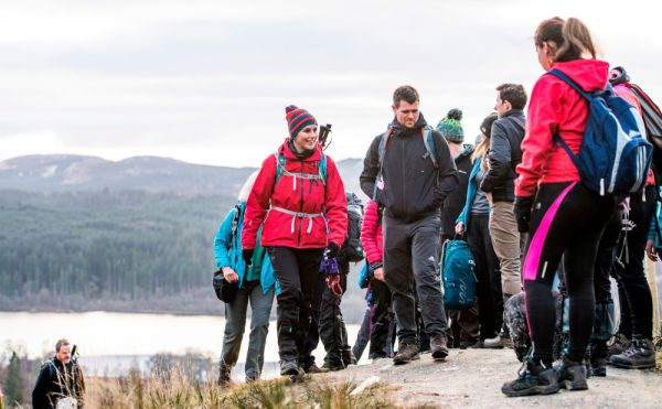 A group of hillwalkers gathering at the top of a hill