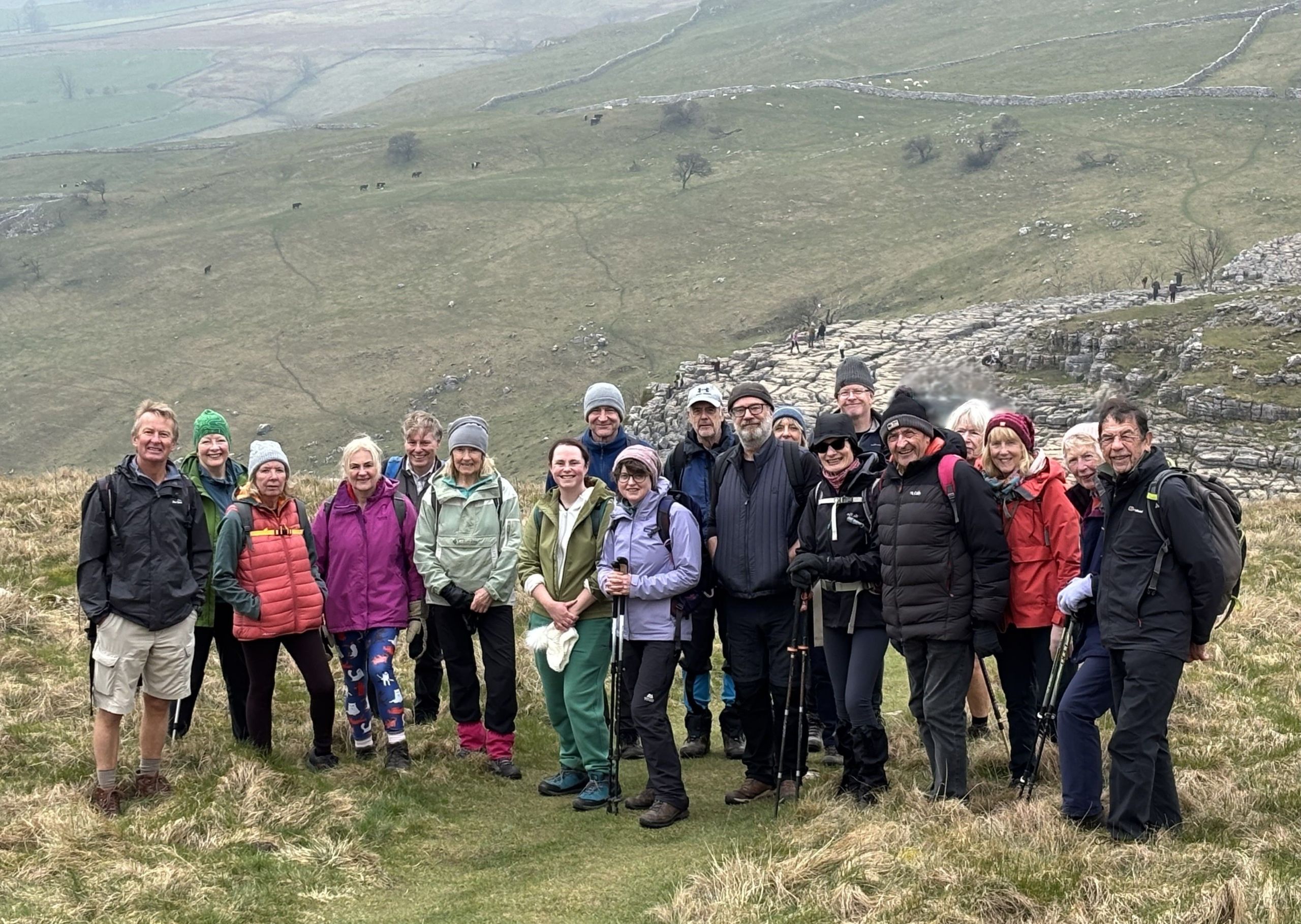 Photo: Craven Ramblers on top of Malham Cove with limestone pavement in the background.